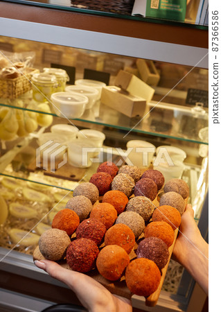 Belper Knolle cheese in the form of small balls. Small Swiss hard cheese balls Belper Knolle. Swiss cheese delicacy concept. Selective focus. 87366586