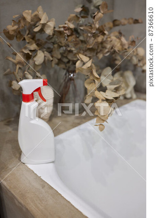 Cropped image of beautiful young woman using a duster and a detergent while cleaning sink and tap in bathroom. 87366610