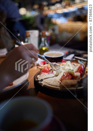 Caprese salad with tomatoes, mozzarella cheese, basil. Dark background. Close up. Top view. 87366623