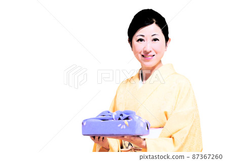 A smiling middle woman wearing a kimono and holding a furoshiki wrap A smiling middle woman wearing a kimono and holding a furoshiki wrap 87367260