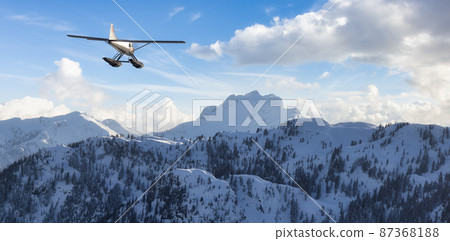 View of Canadian Mountain Landscape with Seaplane Flying. 87368188
