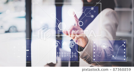 By using a visual indicator on the screen, an IT consultant may manage large amounts of data and analyze financial documents. Technology, Hologram, VR, Metaverse concept. By using a visual indicator on the screen, an IT consultant may manage large amounts of data and analyze financial documents. Technology, Hologram, VR, Metaverse concept. 87368859