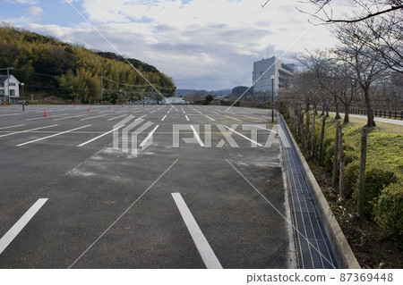 Large parking lot with asphalt pavement Large parking lot with asphalt pavement 87369448