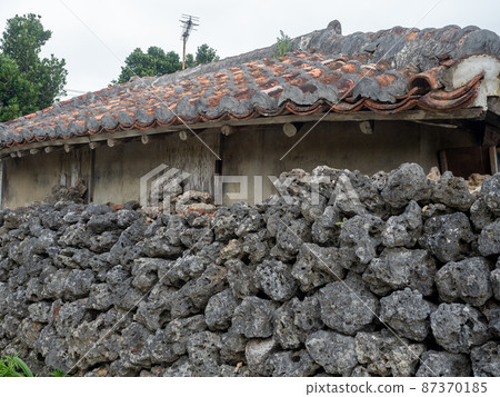Okinawa's old traditional house and stone wall Okinawa's old traditional house and stone wall 87370185