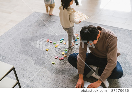 爸爸在家工作，同時照顧孩子 87370686