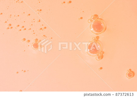 Oil texture with bubbles close-up on pink background Oil texture with bubbles close-up on pink background 87372613