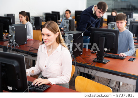 Teacher conducts computer science exam in university class Teacher conducts computer science exam in university class 87373933