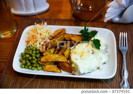 French style meat in Mornay sauce with vegetable garnish French style meat in Mornay sauce with vegetable garnish 87374591