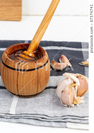 Fermented garlic honey, honey for strong immunity. Vertical photo Fermented garlic honey, honey for strong immunity. Vertical photo 87374741