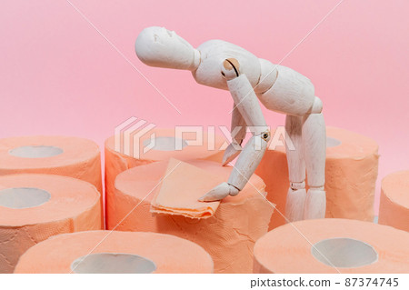 Roll of orange toilet paper on a pink background. Hygiene products. Copy space 87374745