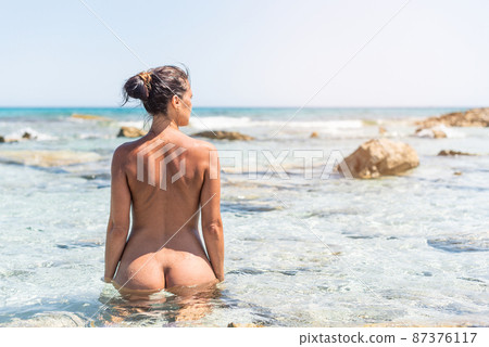 Slim nude woman in water on seashore - Stock Photo 87376117 Xxx Photo