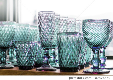 Green aquamarine goblets and glasses for wine in the store on the counter transparent set collection embossed 87376469