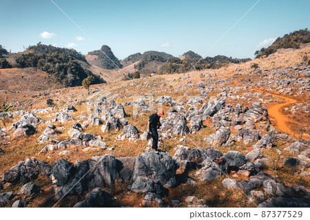 Rocks and farmland are dry during the hot summer days. 87377529