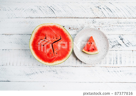 sweet fresh watermelon on white wooden background 87377816