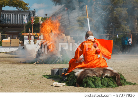 A monk praying for a fire 87377920