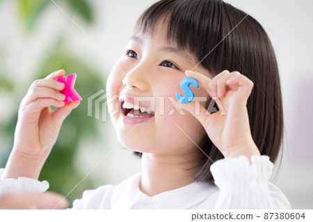 Education: A girl taking lessons in an English conversation class Education: A girl taking lessons in an English conversation class 87380604