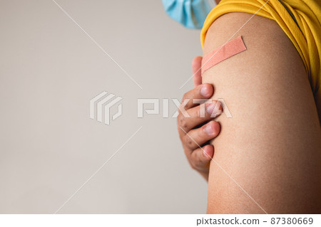 Someone gets Coronavirus vaccine and COVID-19 side effect coverage endorsement. Copy space for text, graphic. 87380669