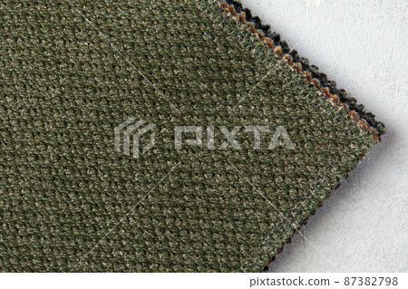 textured background or wallpaper from rough fabric of green lime color and a blank space textured background or wallpaper from rough fabric of green lime color and a blank space 87382798