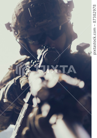 Close up photo of bearded soldier in uniform of special forces in a dangerous military action in a dangerous enemy area. Selective focus  87382978