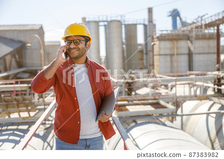 Photo of happy male multiethnic worker in plant 87383982