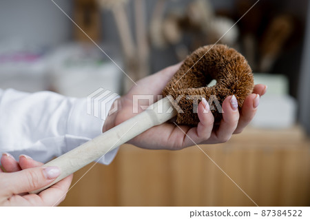 Woman holding eco sponge for washing dishes. Natural products with zero waste 87384522