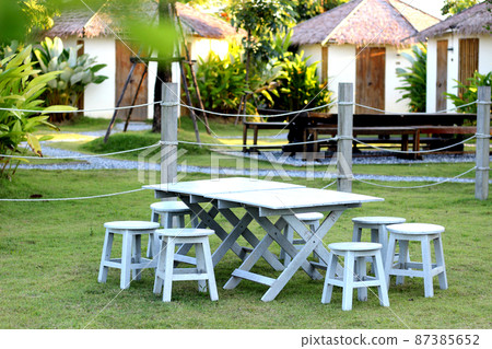 Grey table and chair in the garden Grey table and chair in the garden 87385652