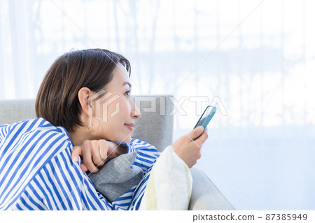Living sofa smartphone woman Living sofa smartphone woman 87385949