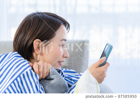 Living sofa smartphone woman Living sofa smartphone woman 87385950