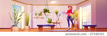 Woman waters plants and flowers at home 87386381