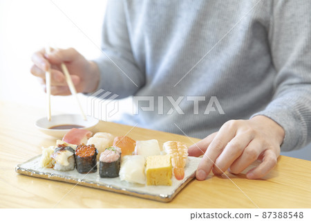 Variations of men eating sushi 87388548