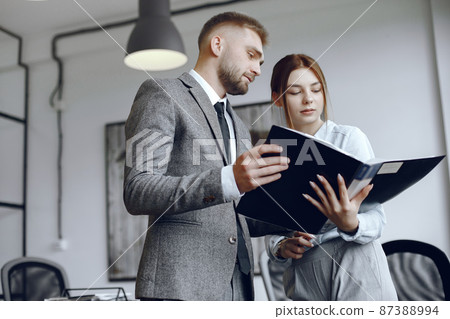 Man and woman read a business contract 87388994
