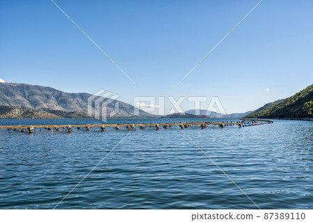 lake with sea water in which mussels are grown near Butrint National Park in southern Albania near Saranda 87389110