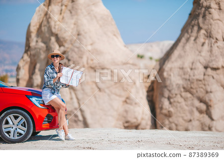 Happy woman on vacation in famous place. Cave formations in Cappadocia 87389369