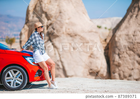 Happy woman on vacation in famous place. Cave formations in Cappadocia 87389371