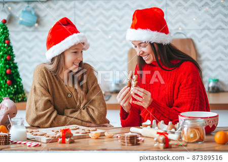 Happy family mother and daughter bake cookies for Christmas 87389516