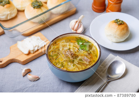 Shchi with pampushki (buns) and lard. Soup of cabbage, potatoes and meat. Traditional Russian and Ukrainian cuisine. Close-up. Shchi with pampushki (buns) and lard. Soup of cabbage, potatoes and meat. Traditional Russian and Ukrainian cuisine. Close-up. 87389780