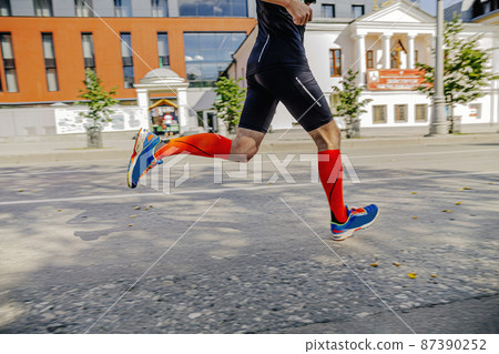male athlete in compression socks running marathon race male athlete in compression socks running marathon race 87390252