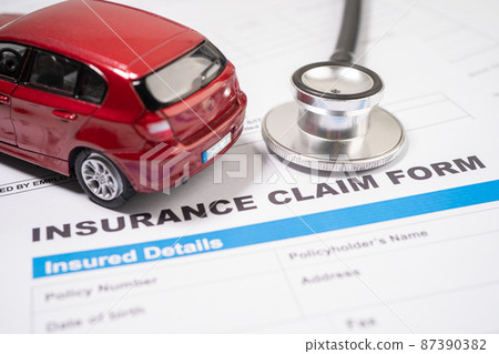 Stethoscope with red car on Insurance  claim accident car form, Car loan, insurance and leasing time concepts. 87390382