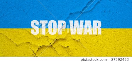 Ukranian flag painted on a concrete wall with Stop war word symbol Ukranian flag painted on a concrete wall with Stop war word symbol 87392433