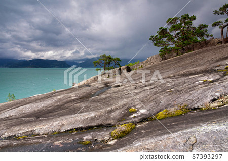 The rocky landmark Hereiane near Jondal on the Hardangerfjord The rocky landmark Hereiane near Jondal on the Hardangerfjord 87393297