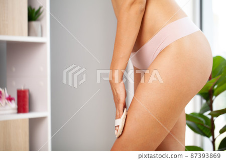 Closeup photo of young woman making a scrub massage 87393869