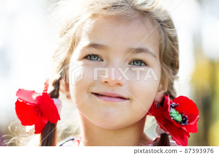 Flag Day of Independence of Ukraine. Stop WAR. Ukrainian girl in an embroidered vyshyvanka shirt with a yellow-blue flag of Ukraine. Symbols of the flag of Ukraine. Freedom. Russia terror. Kyiv. Flag Day of Independence of Ukraine. Stop WAR. Ukrainian girl in an embroidered vyshyvanka shirt with a yellow-blue flag of Ukraine. Symbols of the flag of Ukraine. Freedom. Russia terror. Kyiv. 87393976