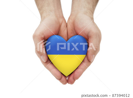 Ukrainian heart in hands isolated on white background with clipping path Ukrainian heart in hands isolated on white background with clipping path 87394012