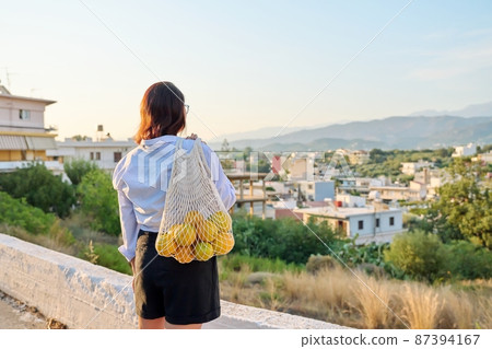 Eco tourism, woman walking relaxing in European mountain village Eco tourism, woman walking relaxing in European mountain village 87394167