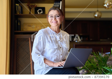 Portrait of smiling middle aged business woman looking at camera. Portrait of smiling middle aged business woman looking at camera. 87394170