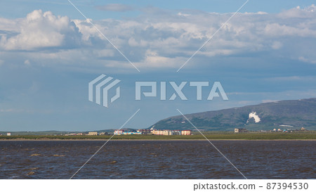 Summer Arctic landscape. View from the sea to colorful buildings in the tundra 87394530