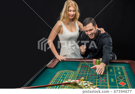 Couple playing roulette wins at the casino. 87394877