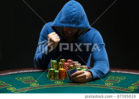Portrait of a professional poker player sitting at pokers table Portrait of a professional poker player sitting at pokers table 87395019