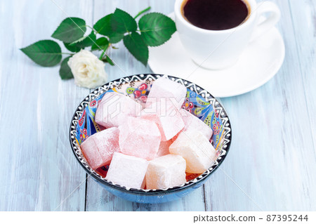 Turkish delight or lokum confection rose and lemon flavored with cup of coffee and rose, horizontal 87395244