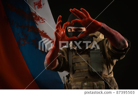 men in military uniform and balaclava with bloody hands show a heart with their own hands against the background of the bloody flag of Russia men in military uniform and balaclava with bloody hands show a heart with their own hands against the background of the bloody flag of Russia 87395503